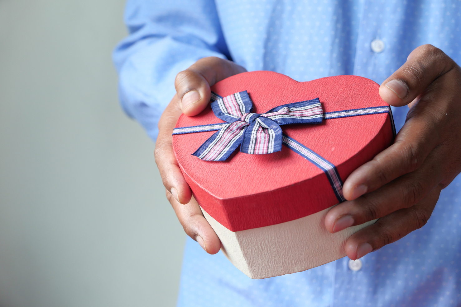 Close up of Man Hand Holding Heart Shape Gift Box